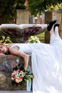 Bride lying on fountain